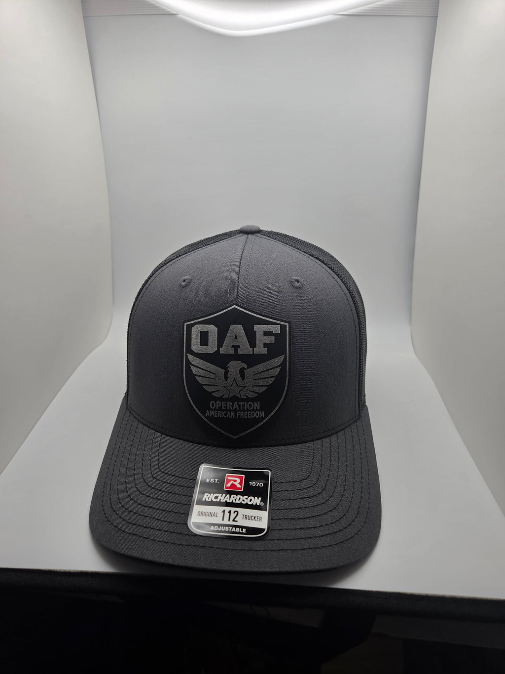 OAF eagle shield patch on a charcoal Richardson 112 trucker hat