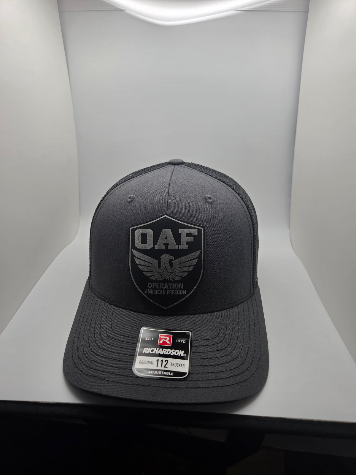 OAF eagle shield patch on a charcoal Richardson 112 trucker hat