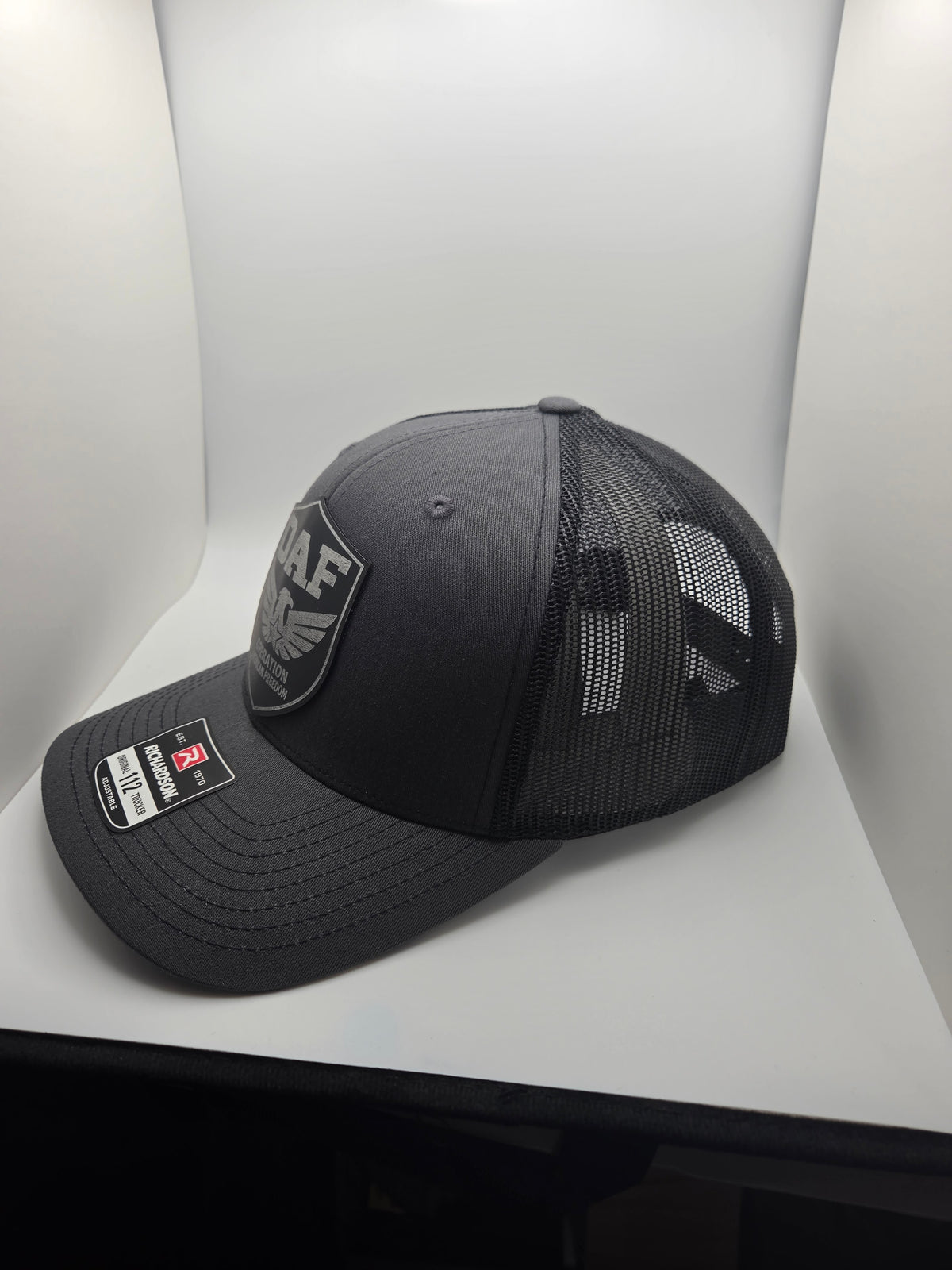 OAF eagle shield patch on a charcoal Richardson 112 trucker hat