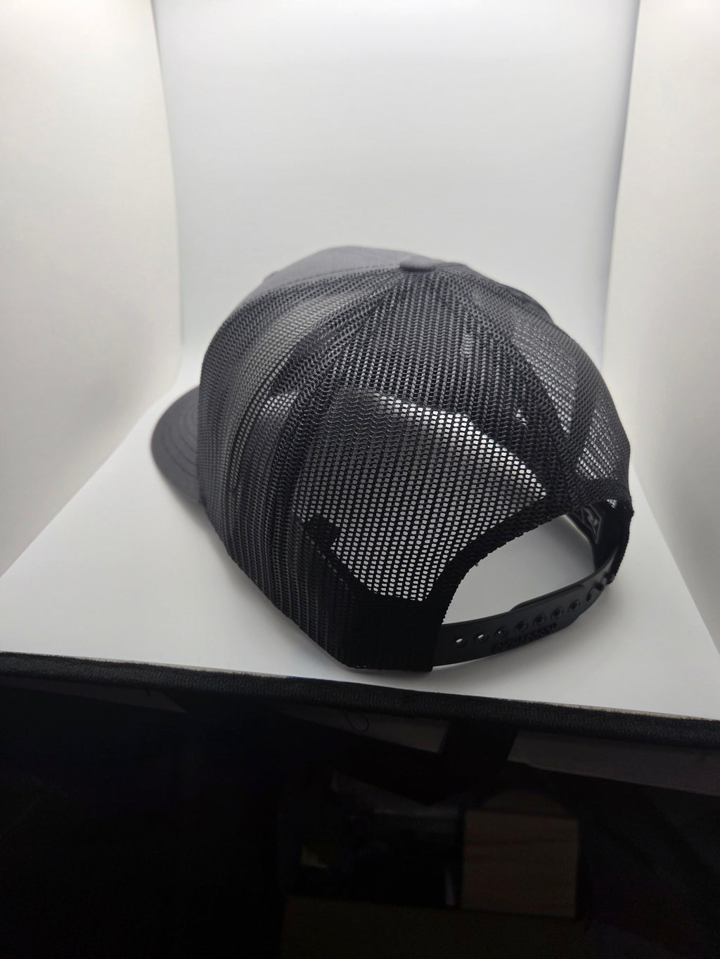 Rear view of the dark mesh Richardson 112 hat with adjustable snapback