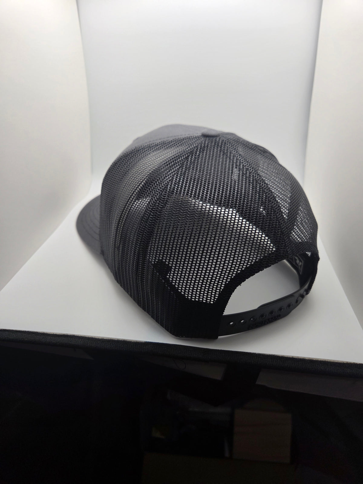 Rear view of the dark mesh Richardson 112 hat with adjustable snapback