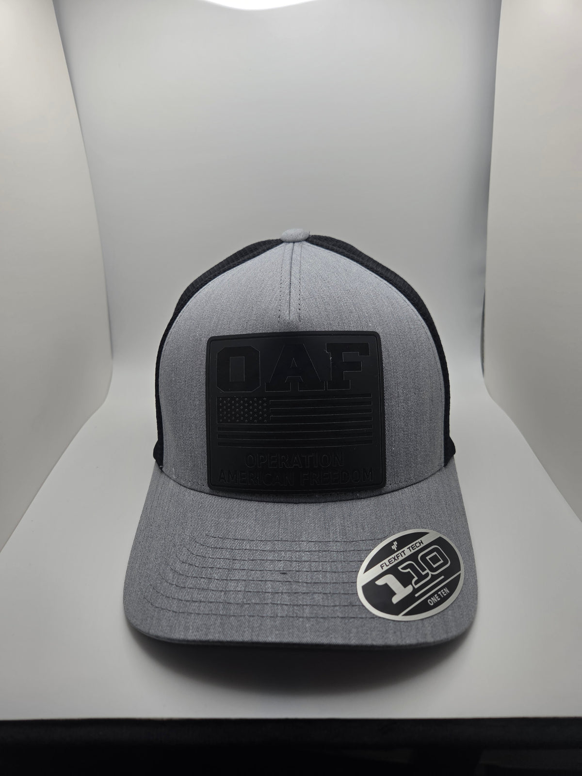 OAF Operation American Freedom black patch on a gray and black Flexfit 110 hat