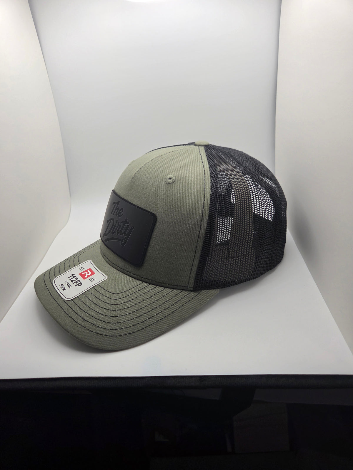 The Dirty black patch Richardson 112FP trucker hat in olive and black
