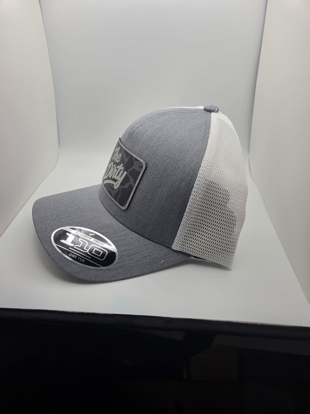 The Dirty dark camo patch Flexfit 110 hat with gray heather-look front and white mesh back