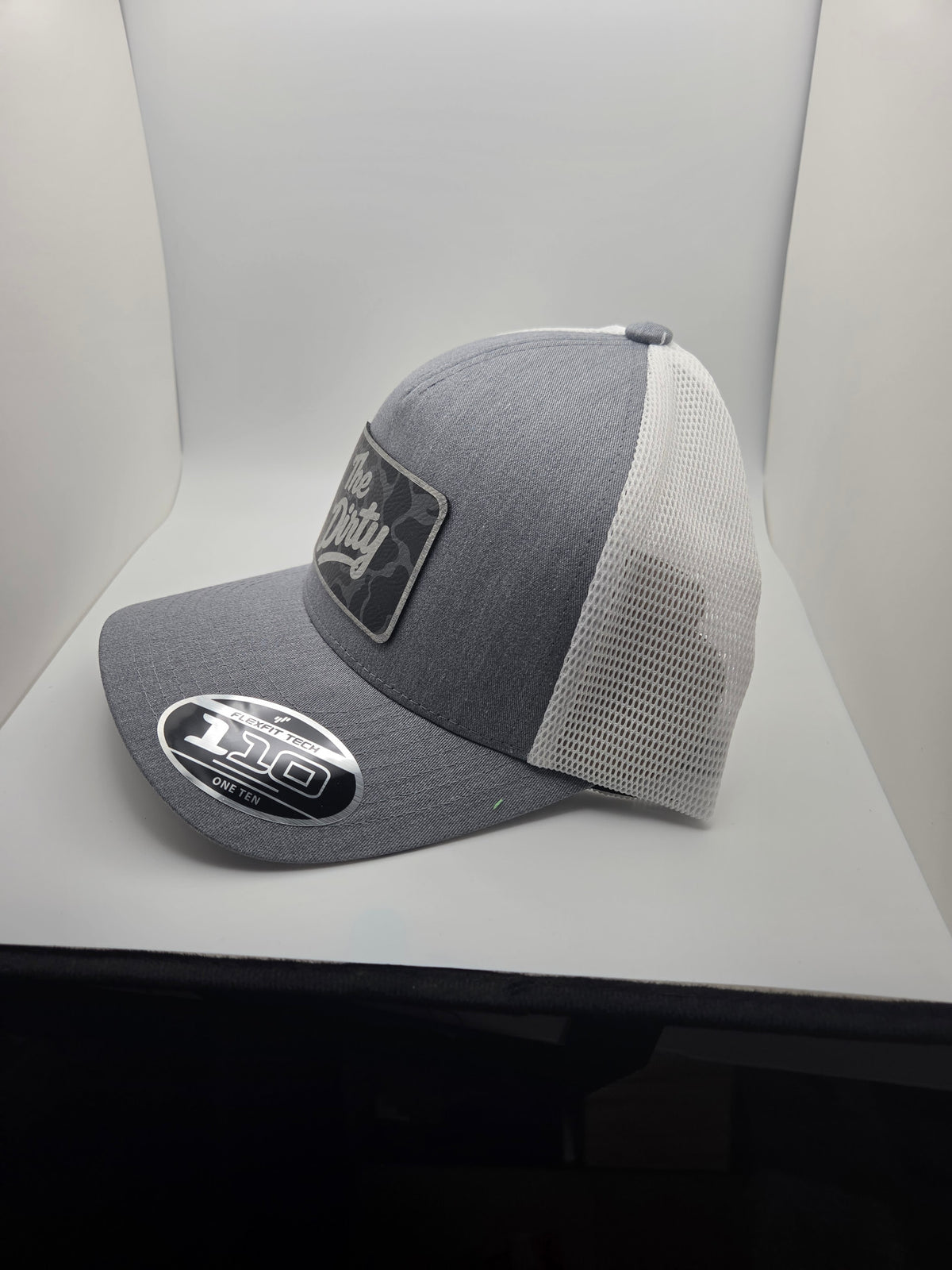 The Dirty dark camo patch Flexfit 110 hat with gray heather-look front and white mesh back