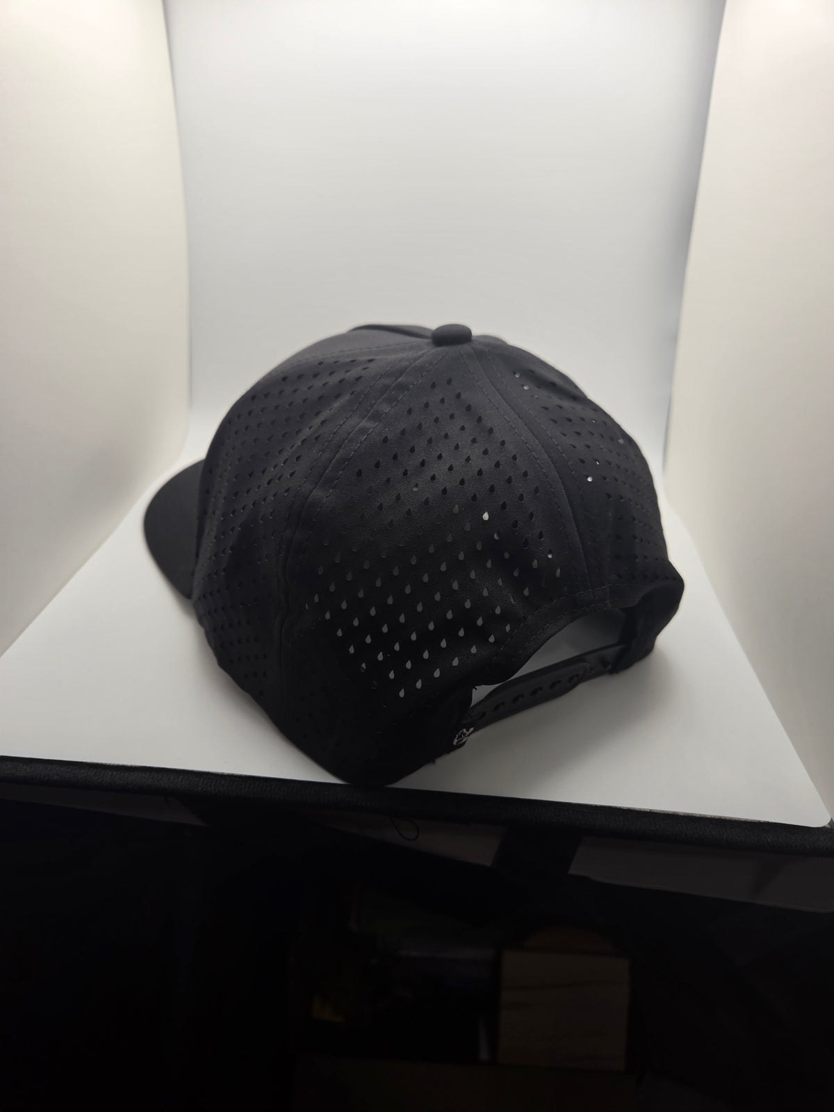 Rear view of black TOAD hat with perforated panels and adjustable snapback